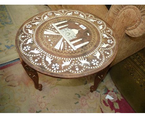 An Eastern hardwood circular occasional Table standing on three elephant trunk form legs, the top elaborately inlaid with mul