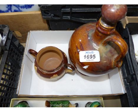 A Royal Doulton Lambeth two handled sucrier and flagon decanter in mottled brown shades.