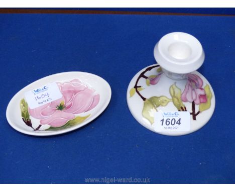 A Moorcroft cream ground Magnolia candlestick and pin dish.