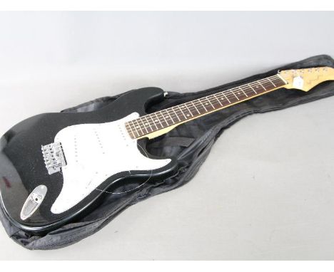 A Pitchmaster six string electric guitar in black finish with carry case. [2]