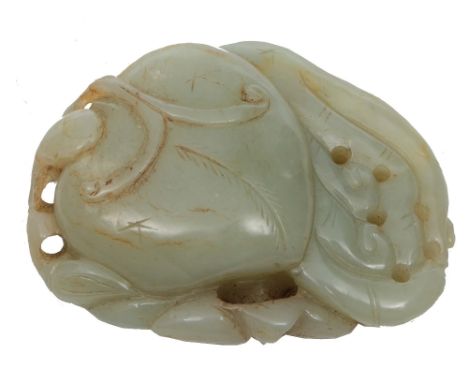 AN EASTERN CARVED JADE PENDANT, the pale jade carved as a fruit and stylised foliage, 7.5cm wide