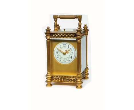 A 19TH CENTURY FRENCH CARRIAGE CLOCK the circular convex white enamel Gothic dial decorated with floral swags and gilt mask, 