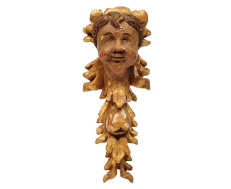 AN 18TH CENTURY CARVED SOFTWOOD AND GILT GESSO WALL BRACKET, carved and polychrome decorated with the head of a cherub, 31cm 
