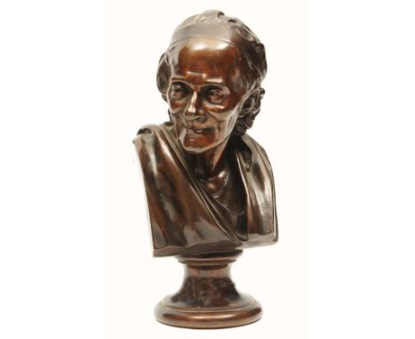 A BRONZE PORTRAIT BUST, with waved hair and wearing a robe, on socle base, 28.5cm high