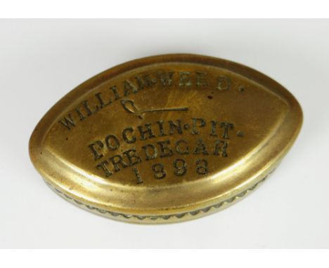 A VICTORIAN BRASS POINTED OVAL SNUFF BOX inscribed in block capitals 'William Weed Pochin Pit Tredegar' 1898, 7cms Condition 