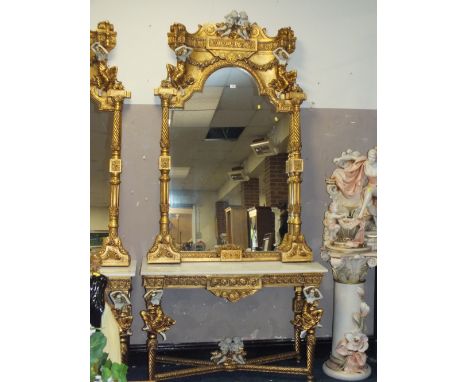 A HUGE GILT MARBLE TOPPED CONSOLE TABLE WITH MIRROR, DECORATED WITH FIGURATIVE CHERUBIC DETAIL - H 260 CM, W 124 CM