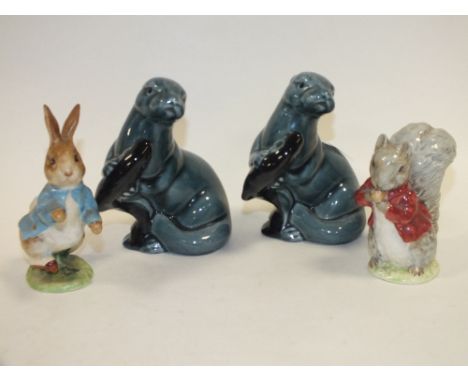 TWO POOLE POTTERY OTTER FIGURES TOGETHER WITH A BESWICK PETER RABBIT AND ANOTHER 