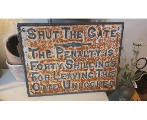 A VINTAGE CAST IRON RAILWAY SIGN 'SHUT THE GATE, THE PENALTY IS FORTY SHILLINGS FOR LEAVING THIS GATE UNLOCKED', WHITE PAINT 
