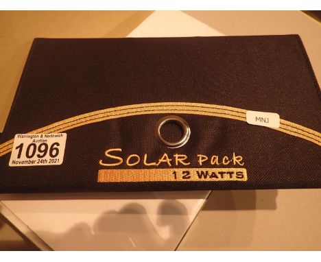 New old stock, 12 watt folding solar panel pack with two USB charging outputs. Integral part of case with magnetic catch and 