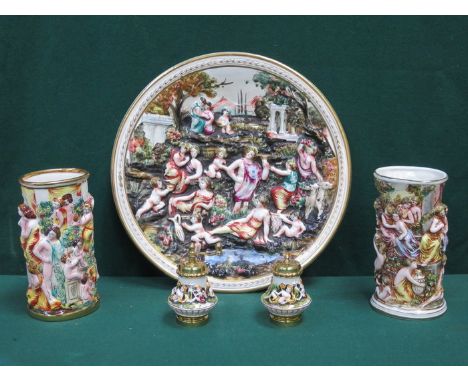 CAPO DIMONTE REPOUSSE DECORATED CIRCULAR CERAMIC WALL PLAQUE, TWO SLEEVE VASES AND SALT AND PEPPER