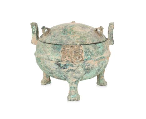 AN ARCHAIC BRONZE RITUAL FOOD VESSEL AND COVER, DING
Late Zhou period, globular vessel with domed cover, three loop handles, 