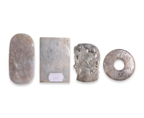 A GROUP OF FOUR JADE PLAQUES
An oval lavender-tone decorated in relief carved scene of two cranes and a pine tree; a rectangu