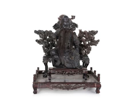 A HARDWOOD MODEL OF GUANDI SEATED ON THRONE STAND
Circa early-mid 20th century, modelled as Guandi with tufts of hair as bear