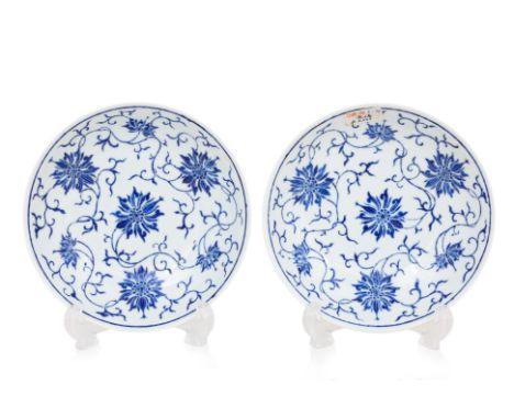 A PAIR OF BLUE ENAMELLED LOTUS VINE DISHES
Circular porcelain dishes with rounded sides, each decorated in seven lotus floret