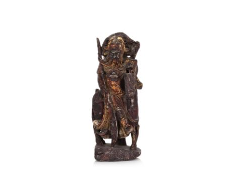 A GILT AND LACQUERED STONE CARVING OF GUANDI WITH HIS HORSE
Late Ming dynasty, soapstone modelled as Guandi riding his horse,