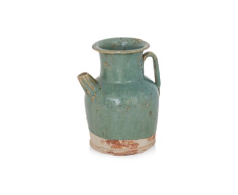 A GREEN-GLAZED EWER
Tang dynasty, small stoneware ewer with strap handle and short conical spout, upright neck and flared rim