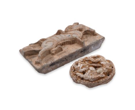 TWO EARLY POTTERY WALL TILES
A rectangular Han dynasty earthenware tile relief decorated in running dog; and a circular tile 