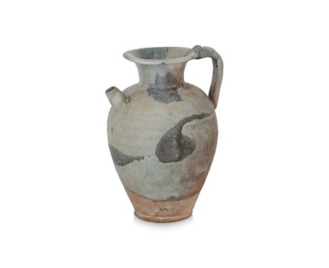 A SPLASH-GLAZED STONEWARE EWER
Tang dynasty, ovoid ewer with strap handle, short conical spout and flanged narrow mouth, cove