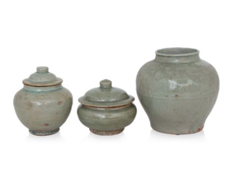 A GROUP OF THREE LONGQUAN CELADON JARS
Ming dynasty, globular squat form jar and domed cover, together with a taller ovoid ja