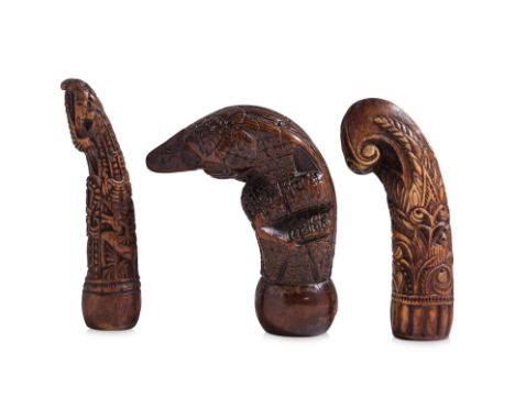 A GROUP OF THREE KRIS HANDLES
Indonesian, two examples in deer antler and the third in softwood of stylised human form
8cm to