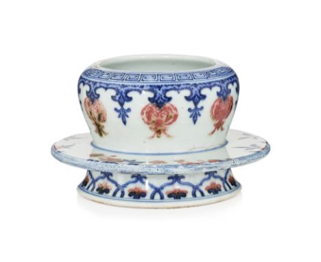 A COPPER RED AND UNDERGLAZE BLUE CUP STAND Deep hollow bowl with inverted rim, painted in underglaze red with a row of pomegr