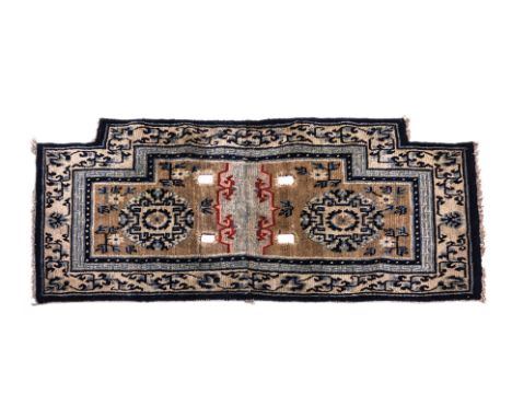 A NAVY BLUE TIBETAN SADDLE RUG
1st half 20th century, hand-knotted wool in blue and beige tones, two circular panels surround