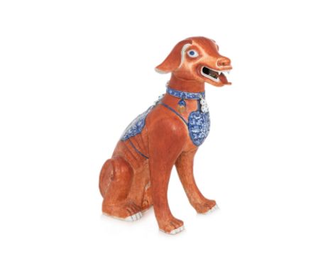 A LARGE PORCELAIN MODEL OF A DOG
Modelled seated with tongue sticking out, painted iron red overglaze body, blue and white co
