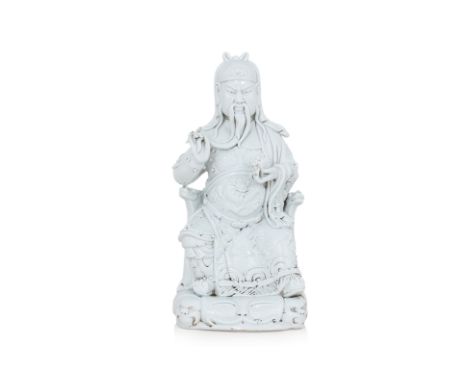 A LARGE BLANC-DE-CHINE SEATED GUANDI
Late 19th/Early 20th century, modelled seated on throne wearing robe over armour, holdin