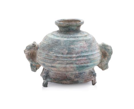 AN INVERTED BRONZE RITUAL VESSEL WITH INTEGRAL COVER, GUI
Late Zhou period, inverted form globular vessel with banded decorat