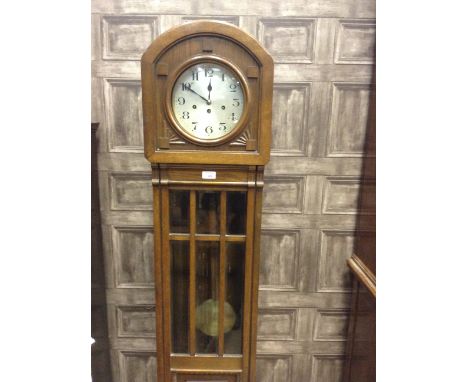 EDWARDIAN GRANDMOTHER CLOCKthe circular silvered dial with Arabic numerals, 8 day chiming movement, contained in an oak case,