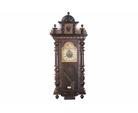 VICTORIAN VIENNA WALL CLOCKthe arch moulded pediment with an arched brass dial below, enamel chapter ring with Roman numerals
