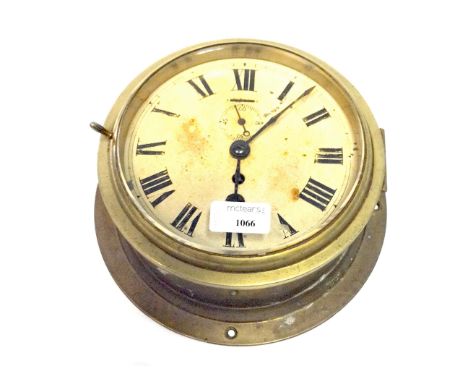 BRASS SHIP'S BULKHEAD CLOCKthe enamel face with Roman numerals, 24cm in diameter