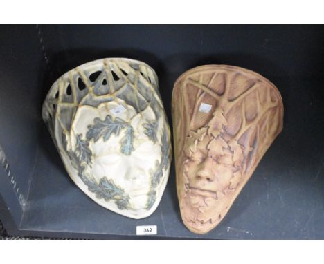 An Art Nouveau design ceramic wall pocket having pierced top, below decorated with female bust intertwined with green foliage