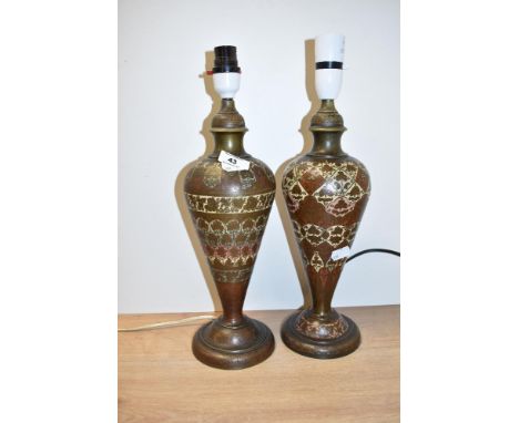 A near pair of brass lamps decorated with floral enamel patterns of blue, yellow and red colour, h32cm