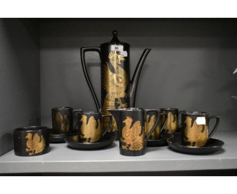 A Portmeirion Phoenix pattern tea service, decorated with gold colour peacocks on a black ground, ( 13 )  Condition report: 1