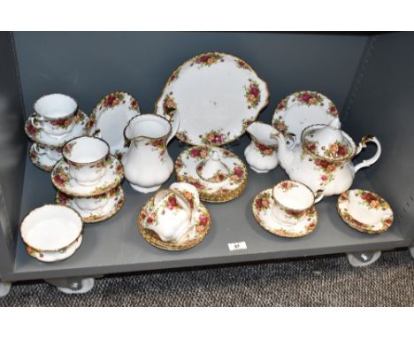 A Royal Albert 'Old Country Rose' bone China tea service, decorated with gilt edging and floral patterns on an ice white grou