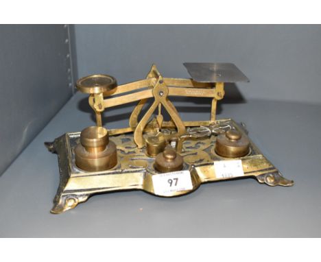 An early 20th century cast brass postal weight scales with weights, sold with sovereign scale, 21cm