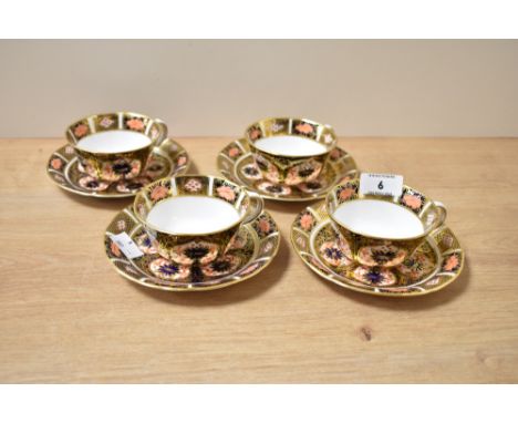 A set of four Royal Crown Derby Old Imari pattern cup and saucers in blue and red with gilt decoration, makers mark to base, 