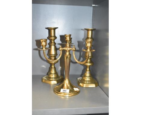 A three arm brass candelabra, h24cm, sold together with a pair of brass candlesticks, ( 3 ).