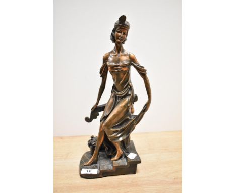 An Art Deco patinated metal sculpture of a female dancer on a three step base, H34cm