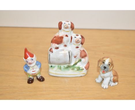A miniature Staffordshire pottery style figure depicting two dogs and barrel, h11cm, sold together with a Noddy figure, h6.5c