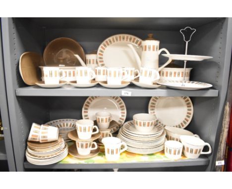 A large vintage dinner service decorated with geometrical patterns on a cream glaze ground, to include cake stand, cups, sauc