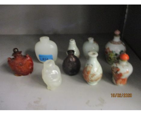 A selection of Chinese and Japanese porcelain and hardstone snuff bottles to include a white Jade example (missing lid) 