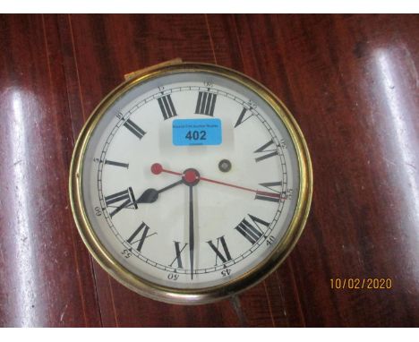 An early 20th century brass ship's clock with key 