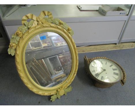 A painted wooden framed oval wall mirror with strut back and an oak cased dial clock with rope twist surround, white enamel R