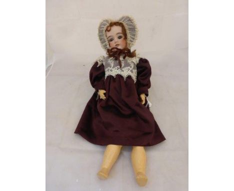 An Armand Marseille 'Floradora' bisque headed doll with composition, articulated limbs with sleepy eyes, an open mouth with t
