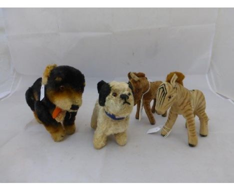 Four assorted soft toys including a Steiff dog, a Chad Valley dog etc. 