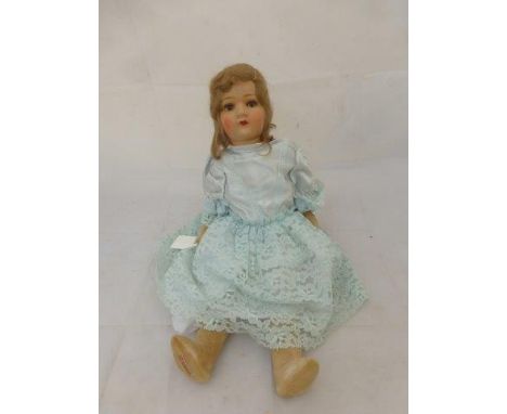 A Chad Valley composition headed doll with brown glass eyes and painted features, velvet limbs, original label of HygienicToy