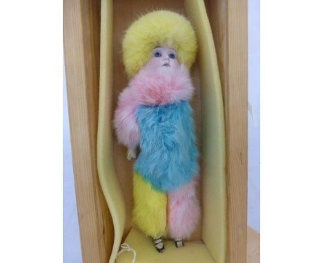 An unusual 20th Century bisque headed doll with faux composition body and limbs with later applied coloured fur. 