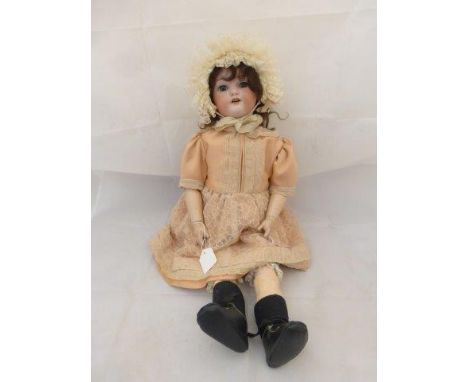 A Simon Halbig Germany bisque headed doll with sleeping eyes, an open mouth with teeth, composition jointed limbs and an impr